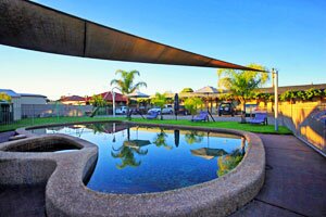 In-ground swimming pool, BBQ and children&rsquo;s play area at Bell Tower Motor Inn